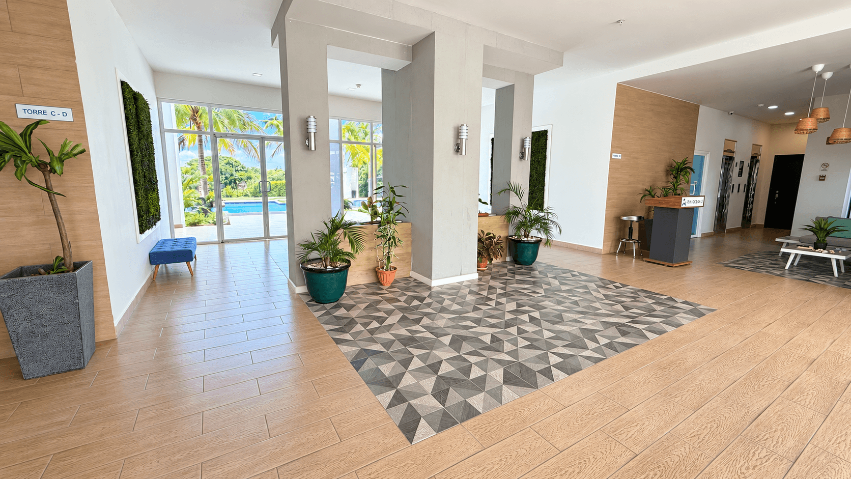 Lobby residencial del edificio con elevadores y recepción